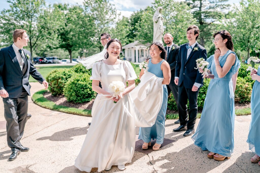 A wedding party in a candid moment in front of the chapel