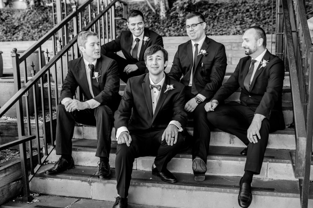 A groom and his groomsmen posed on the Rowley steps after a Marymount University wedding