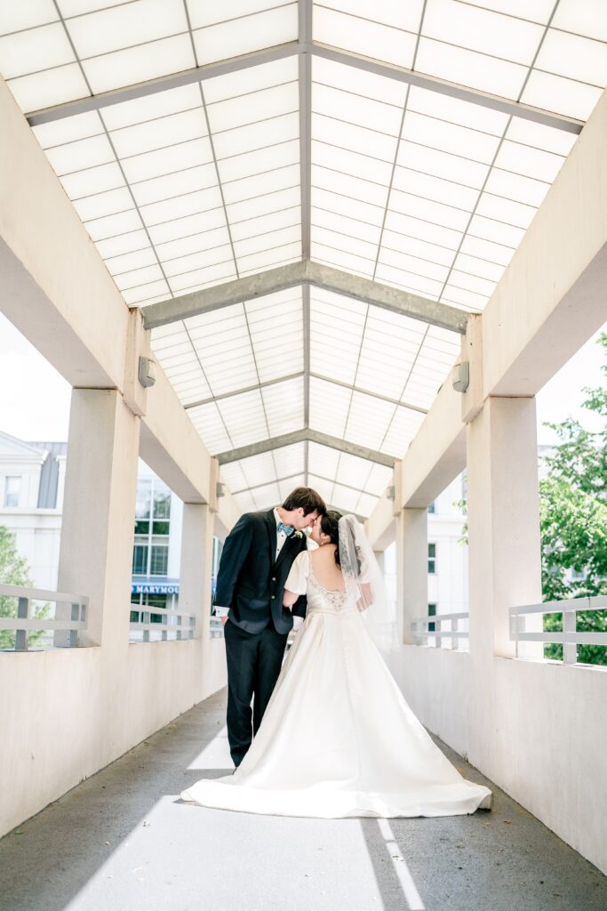 A bride and groom posed for a portrait on the Caruthers bridge during their Marymount University wedding