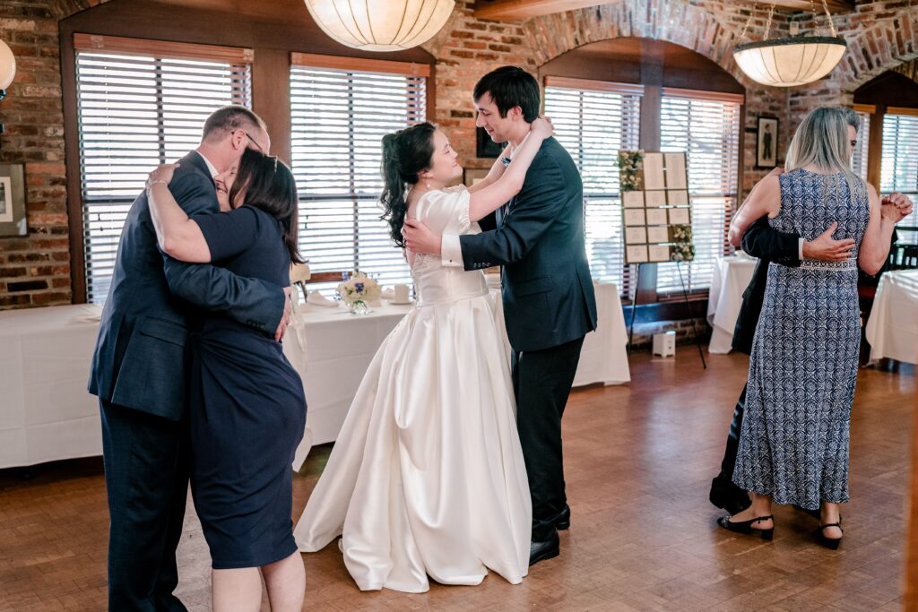 A bride and groom sharing a dance with their parents beside them at their Union Street Public House wedding