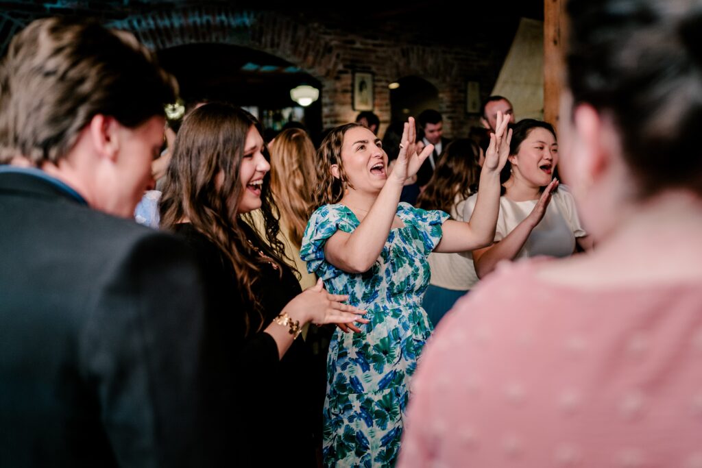 A crowd singing and dancing together during a Union Street Public House wedding