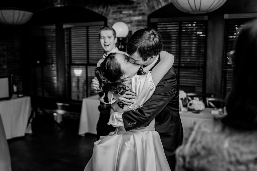 A bride and groom share a kiss on the dance floor during a Union Street Public House wedding