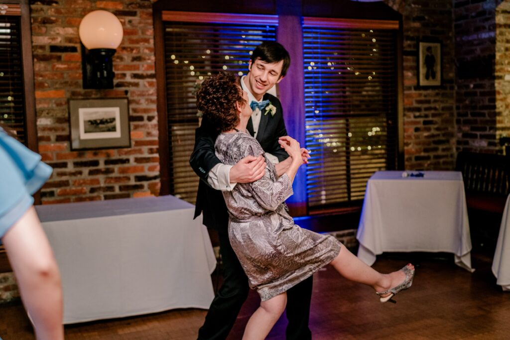 A groom dancing with his grandmother during his Union Street Public House wedding