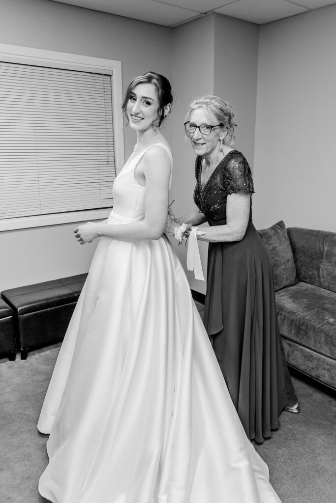 A bride and her mom getting ready for her ceremony