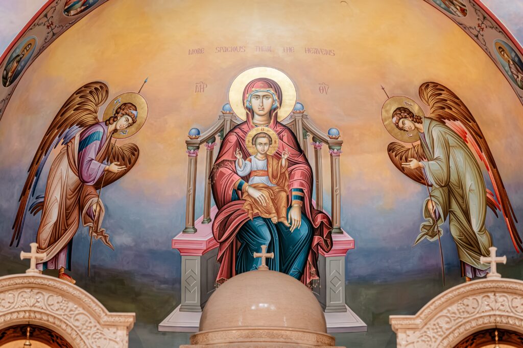The fresco of the Madonna and Child with angels at a church with a colorful wedding photographer
