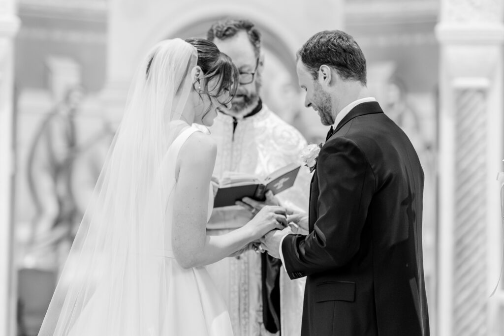 A bride and groom exchanging rings for their Greek Orthodox wedding