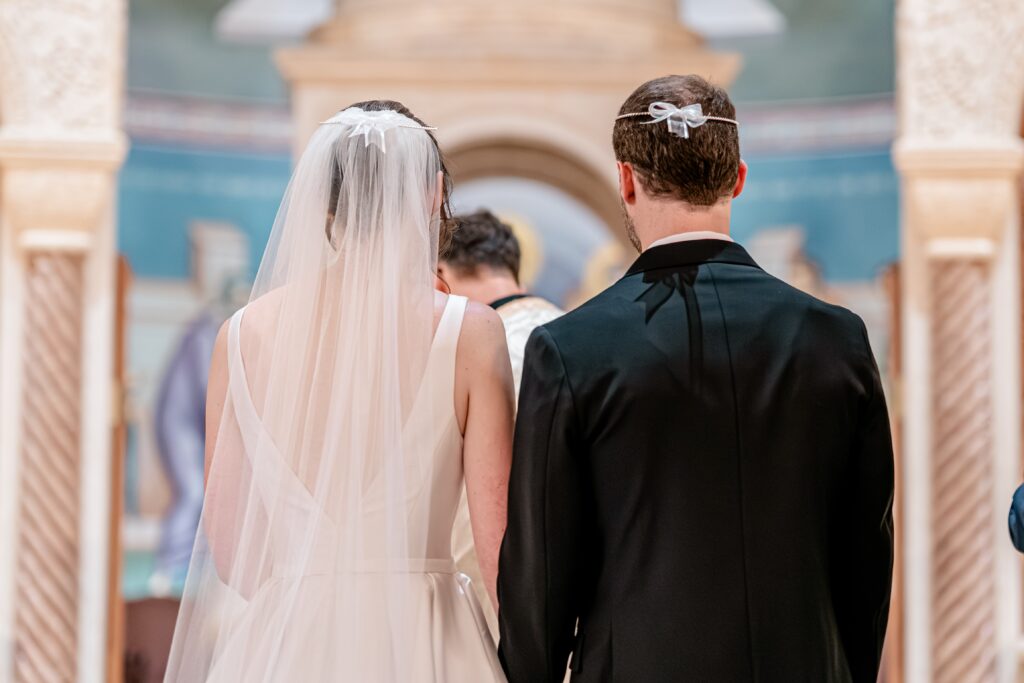 A close up of a bride and groom wearing their crowns during a Sts. Peter and Paul Antiochian Orthodox Church wedding in Potomac, Maryland