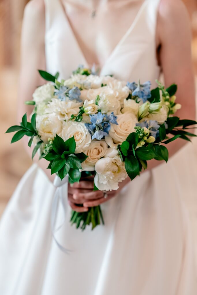 A classic bridal bouquet with white and blue flowers at a Sts. Peter and Paul Antiochian Orthodox Church wedding in Potomac, Maryland