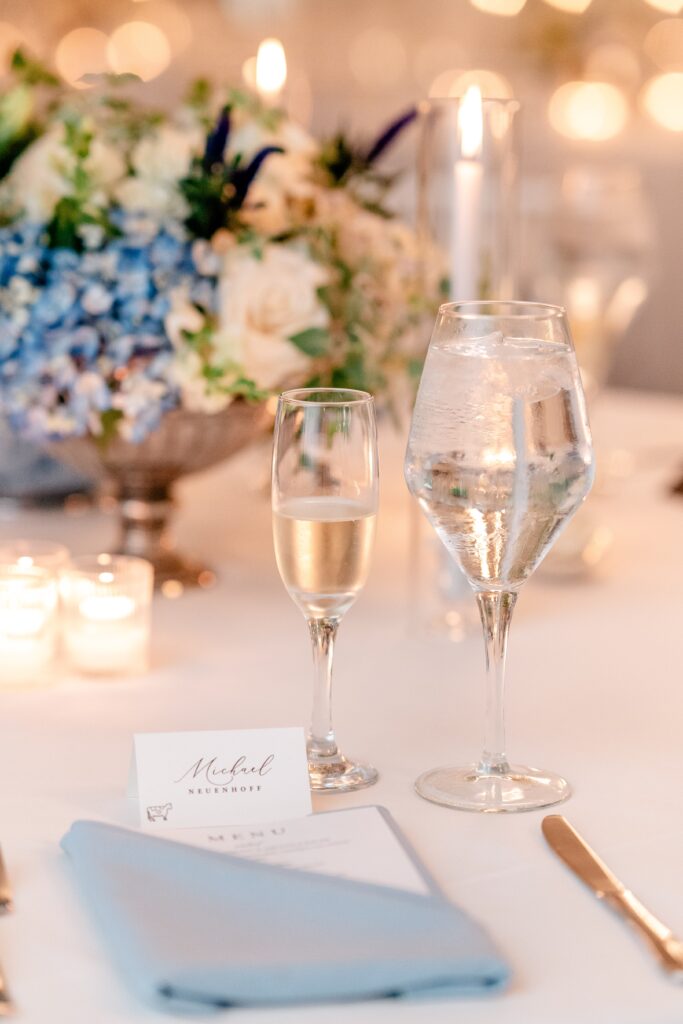 A close up of a champagne glass on a reception table by a colorful wedding photographer