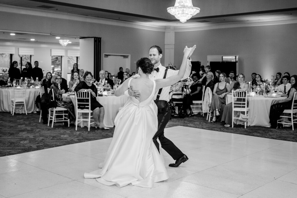 A bride and groom sharing a dip during their first dance after their Greek Orthodox wedding