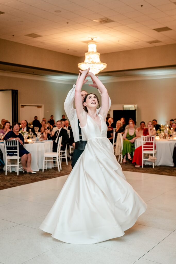 A bride and groom twirling during their first dance for their Sts. Peter and Paul Antiochian Orthodox Church wedding in Potomac, Maryland