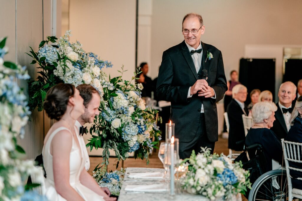 A father giving a toast to the newlyweds after a Greek Orthodox wedding