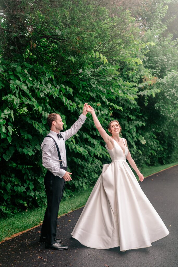 A bride and groom twirling together the day of their Greek Orthodox wedding