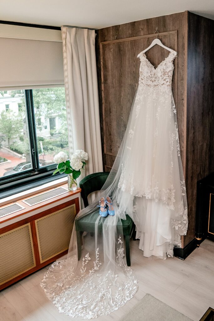 A wedding dress hanging in a vintage inspired hotel room