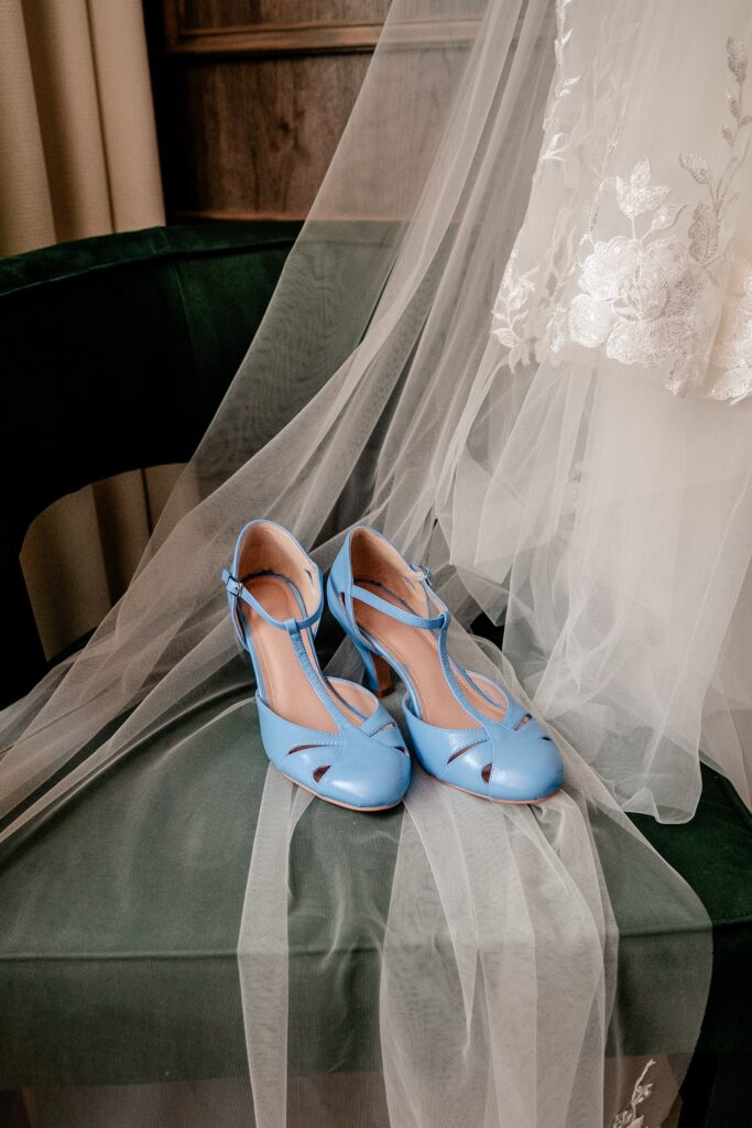 A pair of custom blue shoes before an Immaculate Conception Church wedding