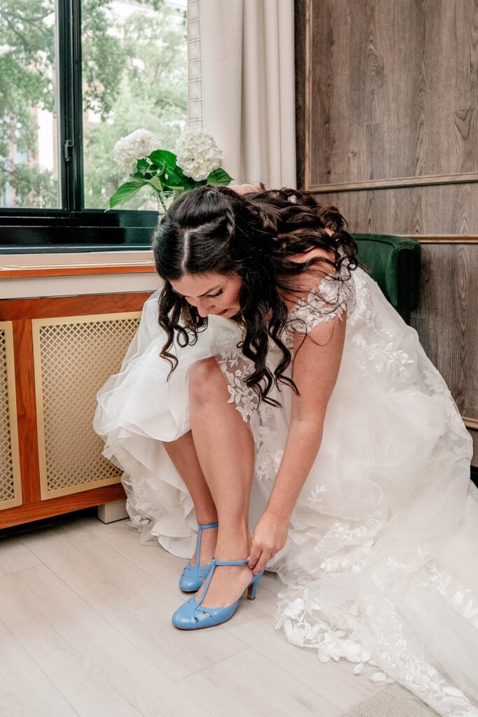 A bride putting on her shoes before her ceremony by a Washington DC wedding photographer
