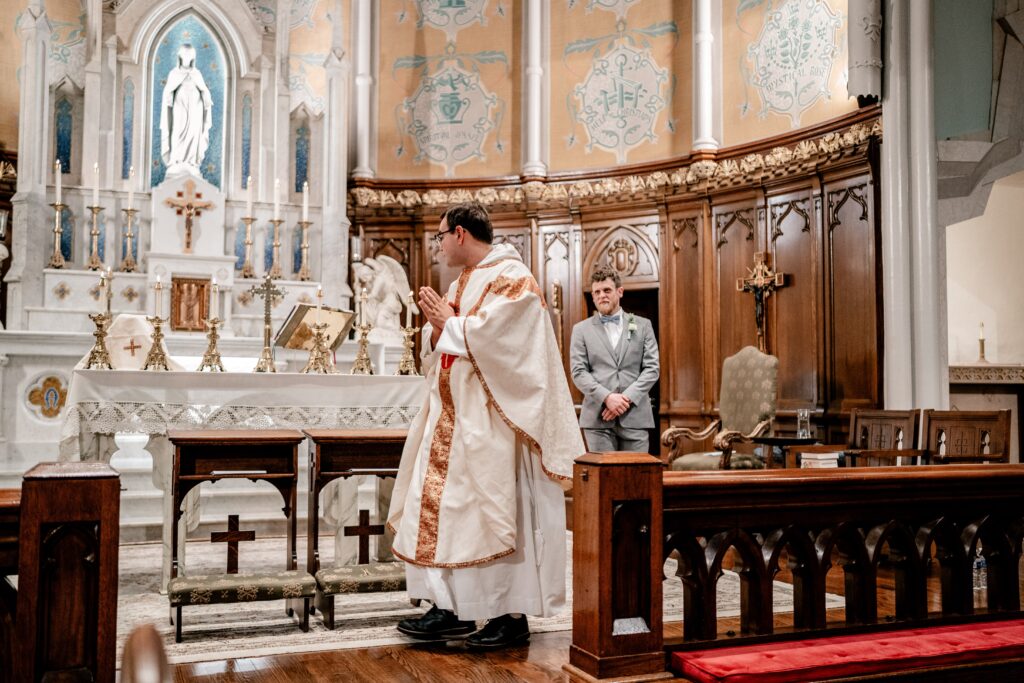 A groom entering his Immaculate Conception Church wedding