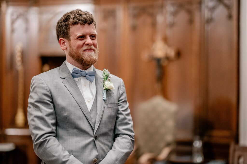 A groom watching his bride during an Immaculate Conception Church wedding
