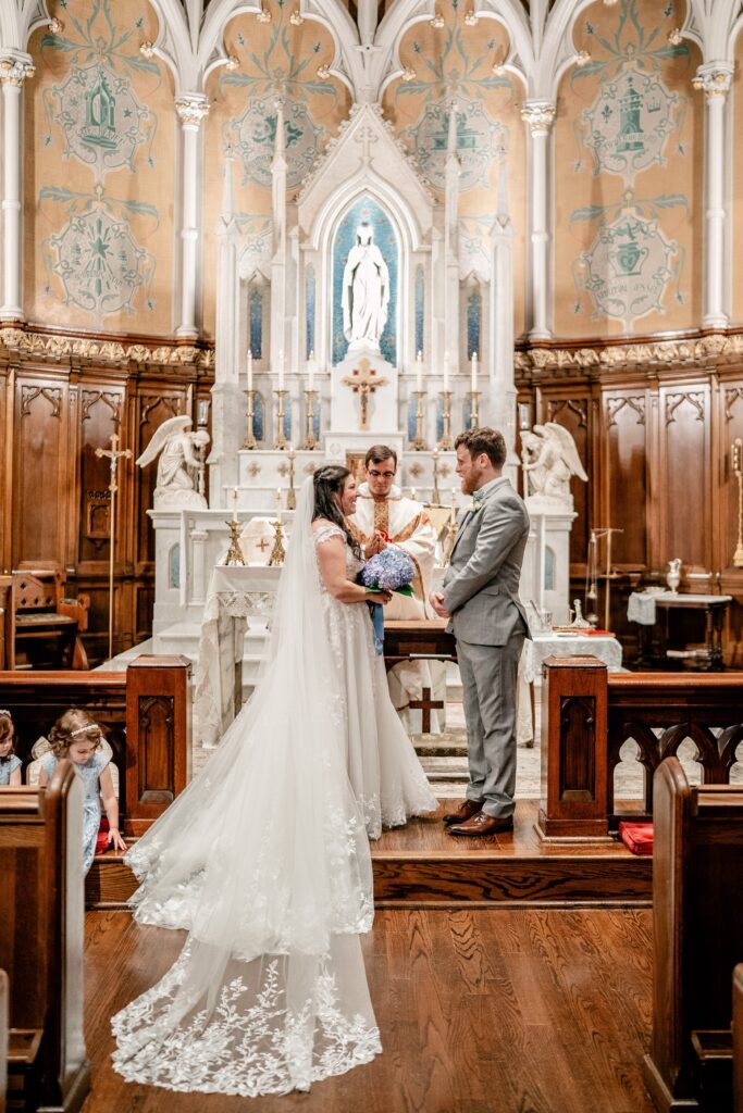 A bride and groom at the altar for an Immaculate Conception Church wedding