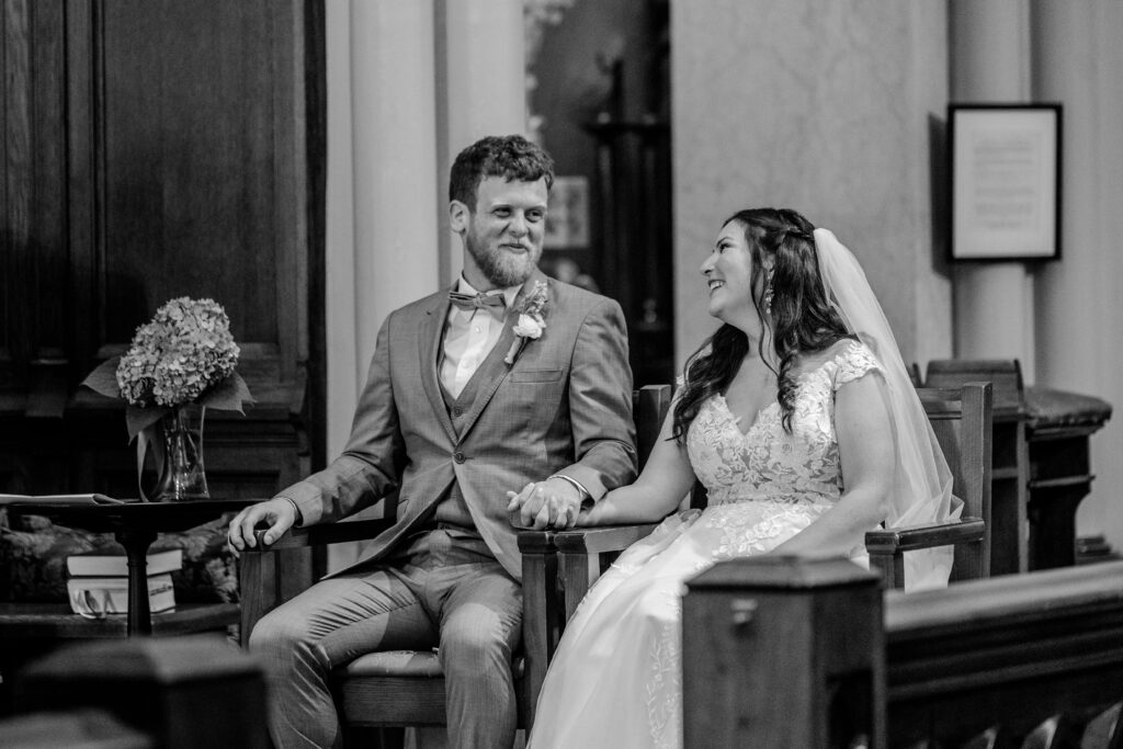 A bride and groom smiling at each other during their Immaculate Conception Church wedding
