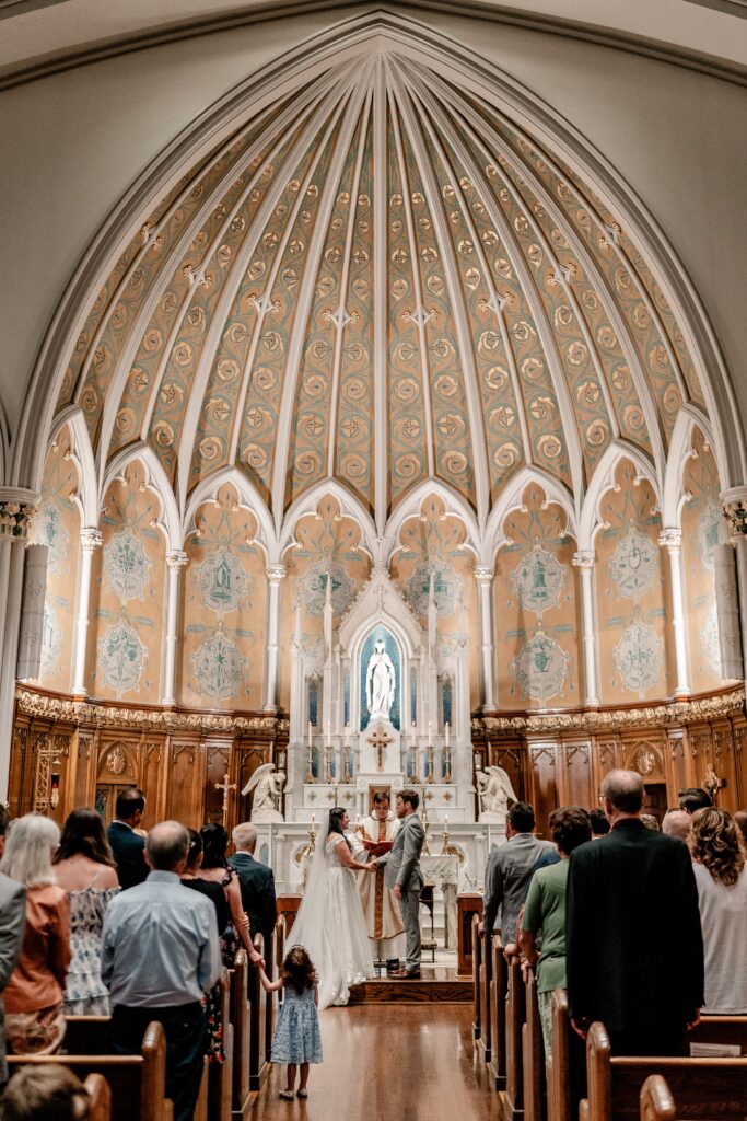 A wide shot of the ceremony during the exchange of vows by a Washington DC wedding photographer