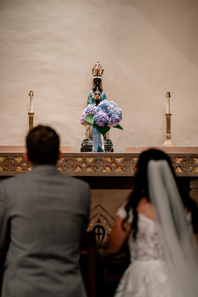 A Mary statue with hydrangeas by Catholic wedding photographer