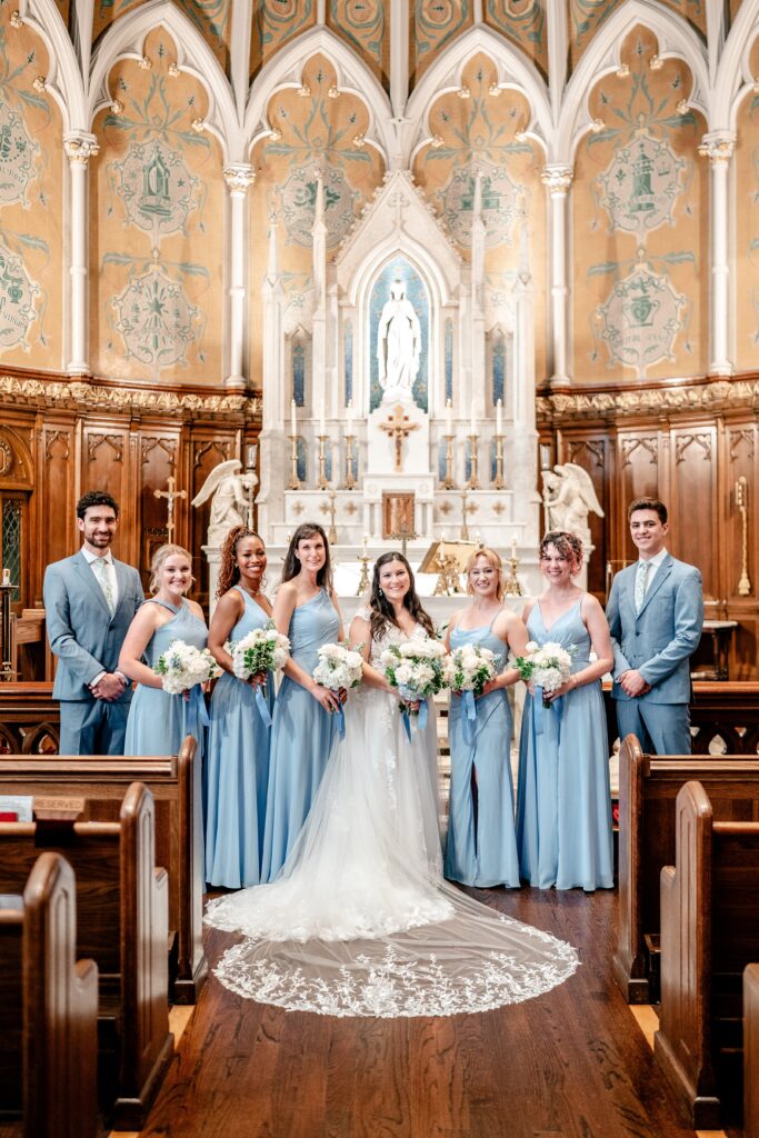 A bride and her bridal party posing for a classic portrait by a Washington DC wedding photographer
