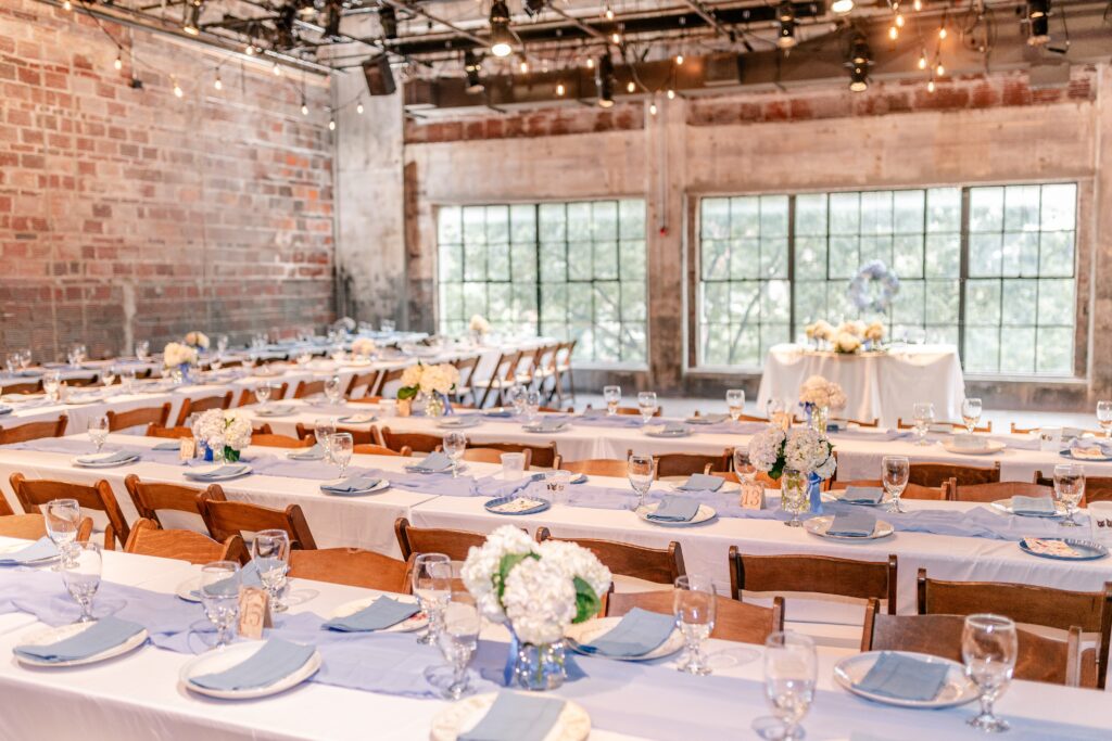 A wide shot of a wedding reception at Studio Theatre featuring light blue decor