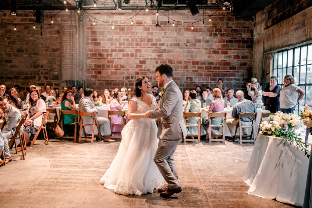 A bride and groom share their first dance after their Immaculate Conception Church wedding