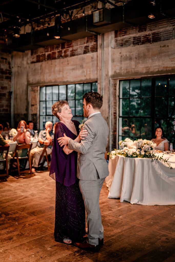 A groom dancing with his mom during his wedding reception at Studio Theatre