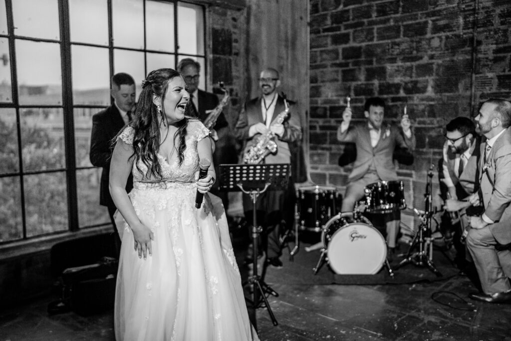 A bride and groom performing with their friends after their Immaculate Conception Church wedding