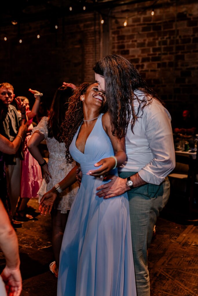A bridesmaid dancing with her partner at a wedding reception