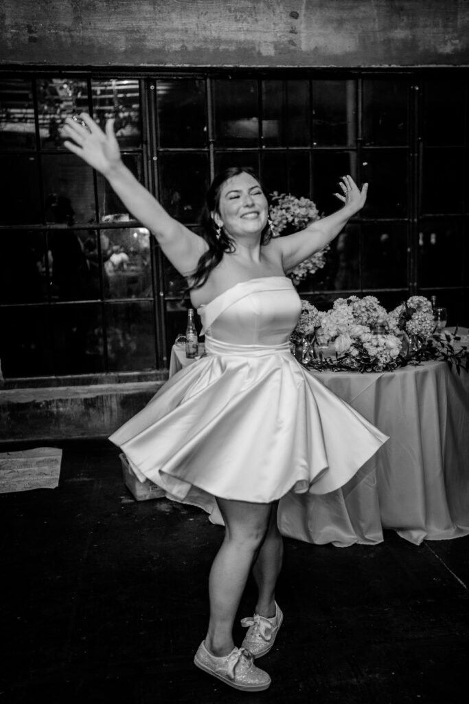 A bride twirling in her reception dress after her Immaculate Conception Church wedding