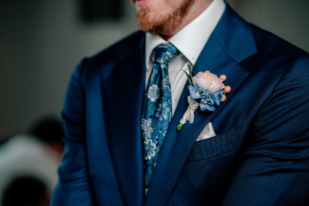 A boutonnière pinned on a groom before his Meadowlark Botanical Gardens wedding