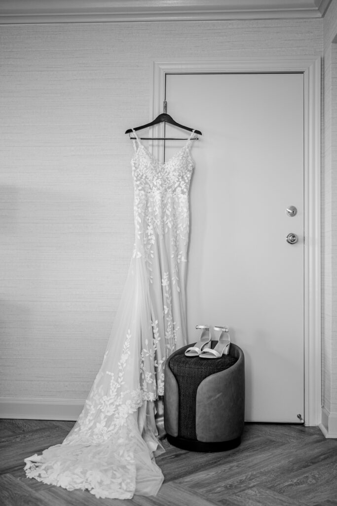 A wedding dress hanging in a hotel room