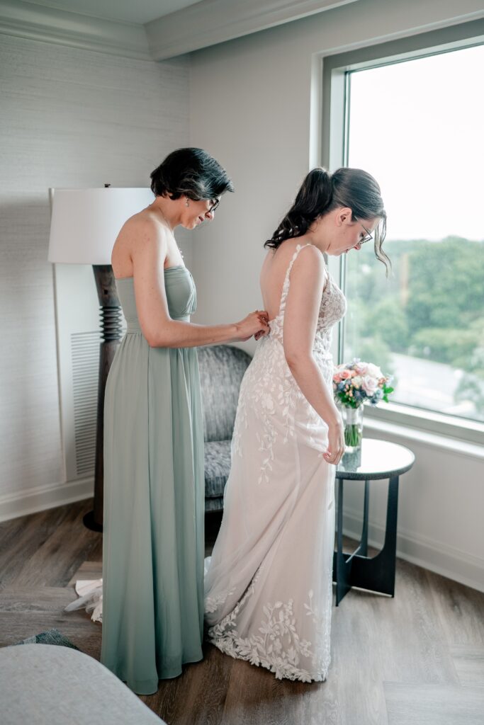 A bride and her sister getting ready before her Atrium at Meadowlark wedding