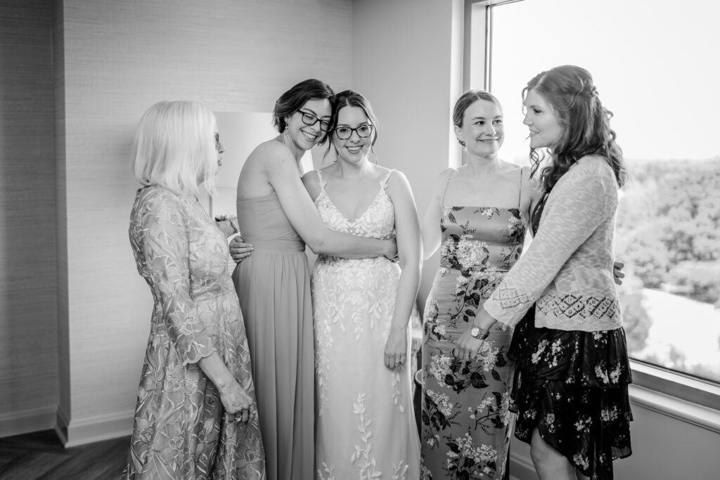 A group of women helping the bride get ready in a candid image by a Northern Virginia wedding photographer