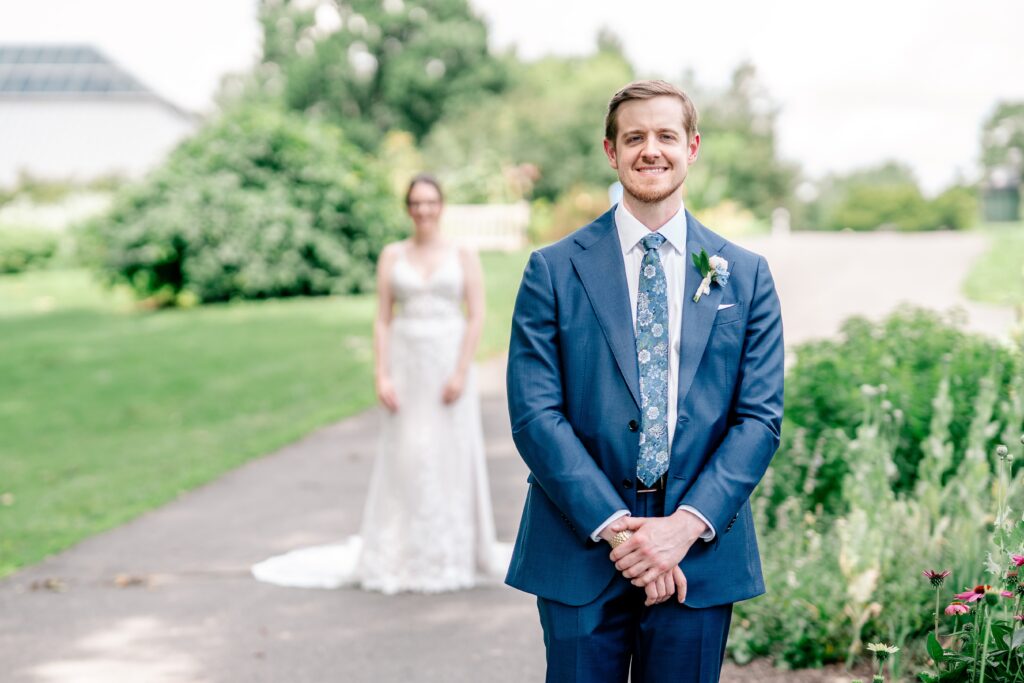 A groom smiling before their first look