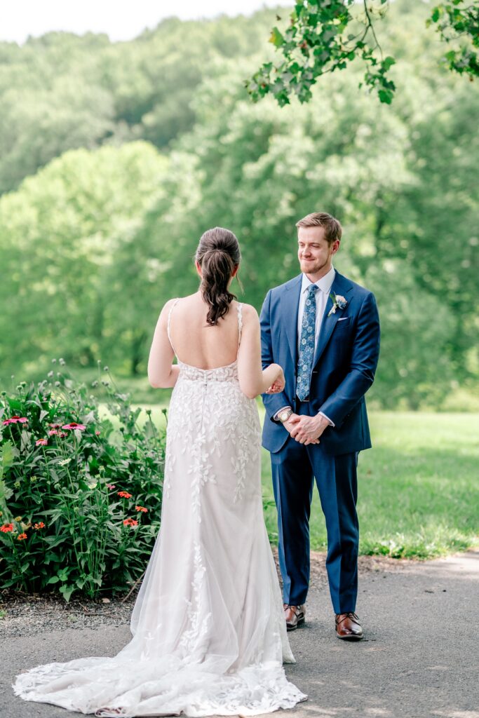A groom seeing his bride for the first time during their Atrium at Meadowlark wedding