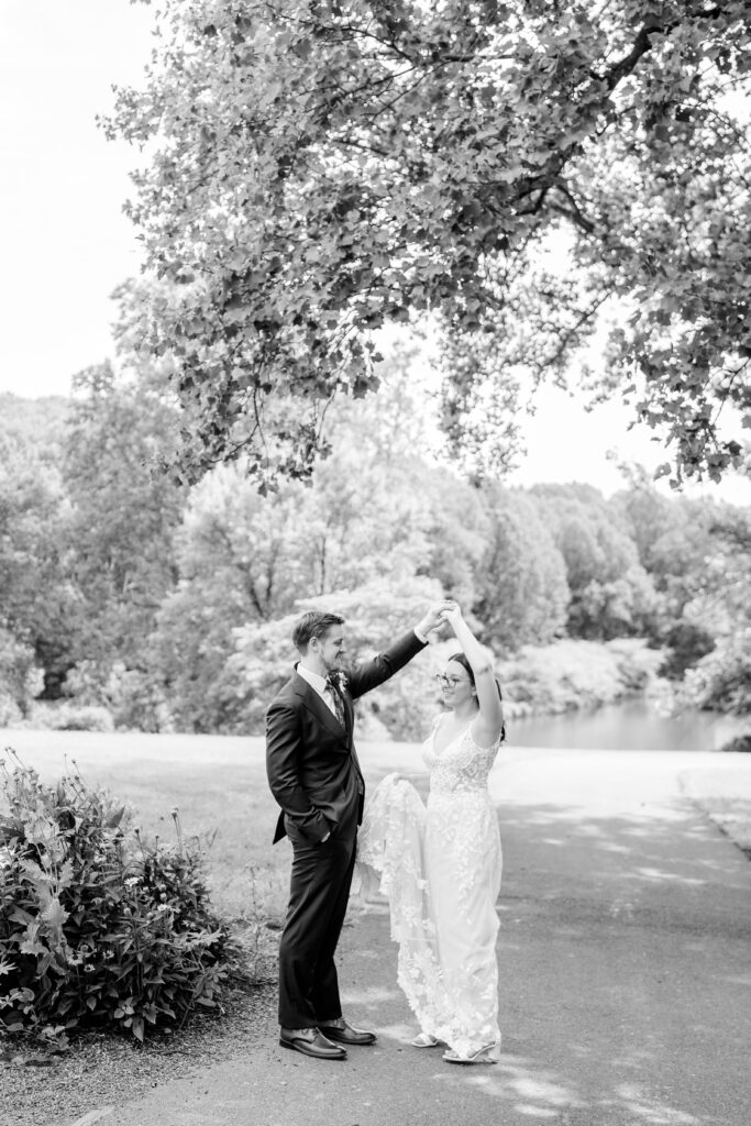 A groom twirls his bride