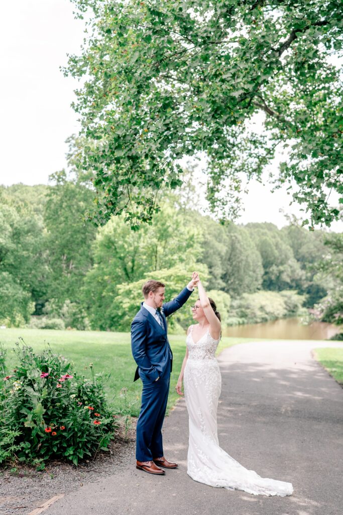 A groom twirls his bride during their Meadowlark Botanical Gardens wedding