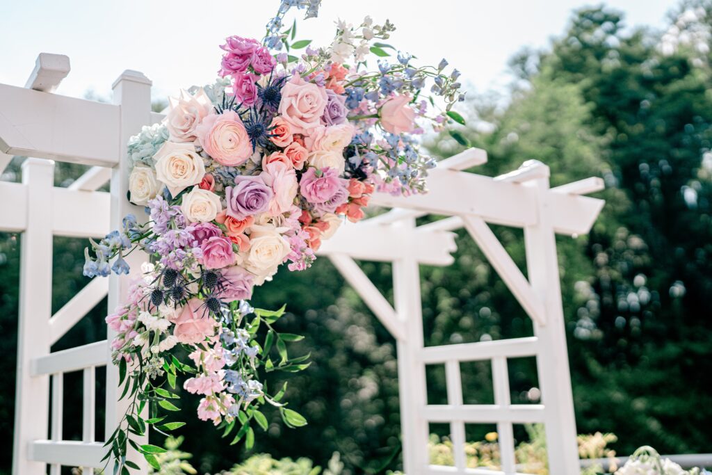A ceremony arch featuring vibrant spring flowers