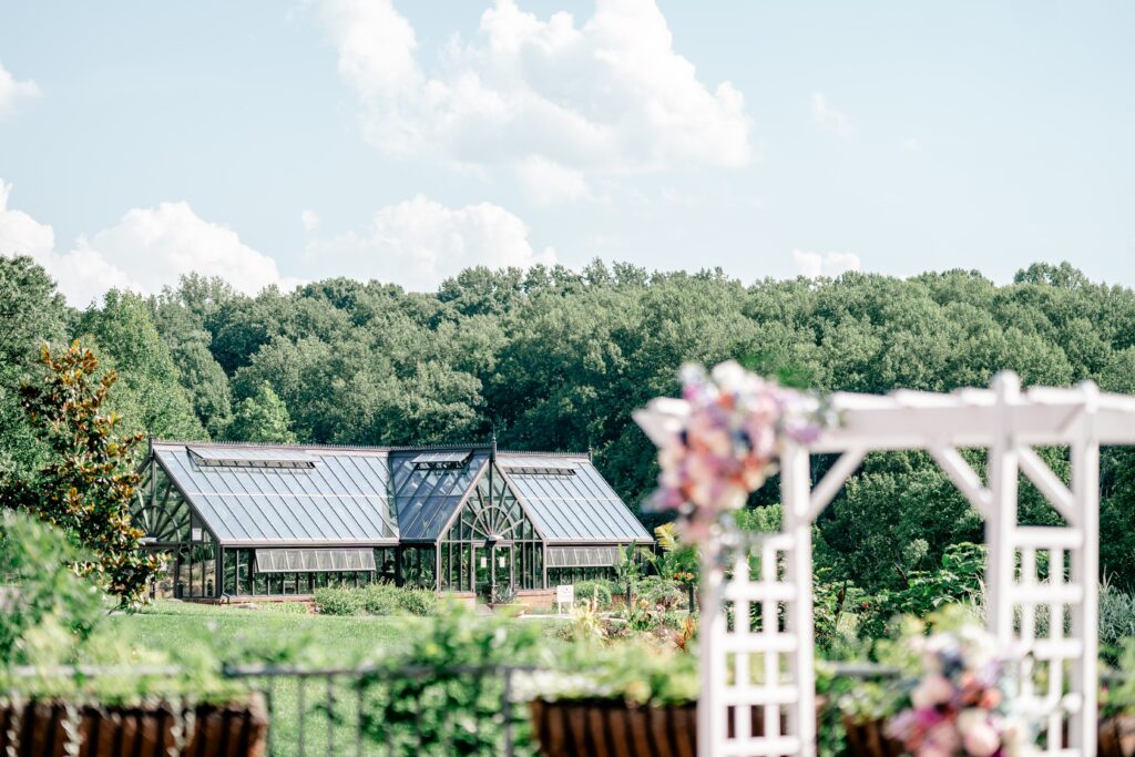The Conservatory in the background at an Atrium at Meadowlark wedding