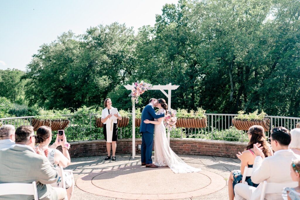A bride and groom kiss as husband and wife during their Meadowlark Botanical Gardens wedding