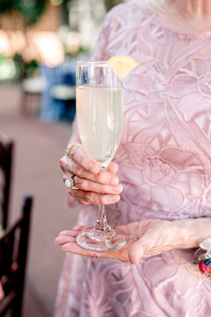 A signature cocktail held by a guest during an Atrium at Meadowlark wedding
