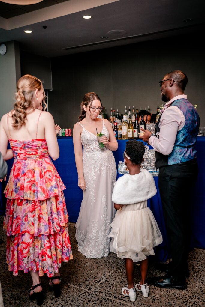 A bride chatting with guests by the bar