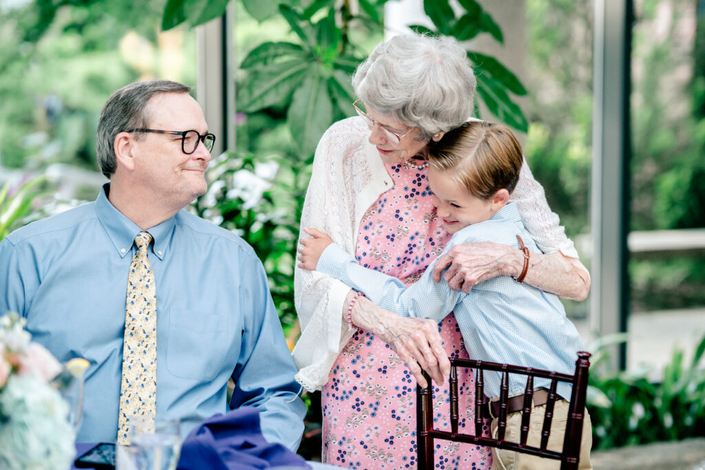 A boy hugging his grandmother during a Meadowlark Botanical Gardens wedding