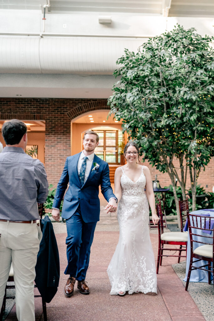 A bride and groom make their reception entrance during a Meadowlark Botanical Gardens wedding