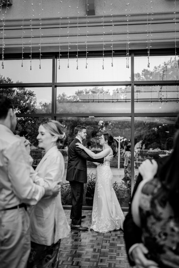A bride and groom share the dance floor with their guests during their Meadowlark Botanical Gardens wedding