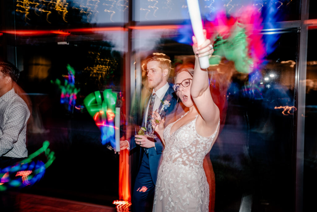A bride and groom celebrate with glow sticks during their Meadowlark Botanical Gardens wedding
